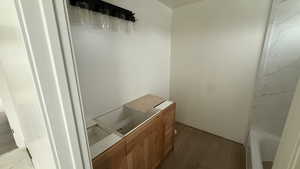Full bathroom with vanity, a bath, and dark wood-style flooring