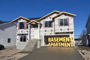 Unfinished property with an attached garage and driveway