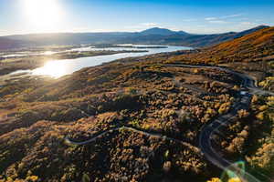 Aerial view of property and surrounding area with a water and mountain view