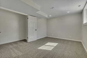 Empty room featuring light colored carpet and recessed lighting