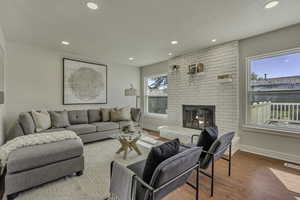 Living area featuring wood finished floors, recessed lighting, and a fireplace