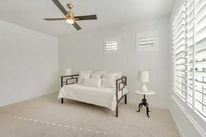 Carpeted bedroom with baseboards and ceiling fan