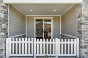 Entrance to property featuring stone siding
