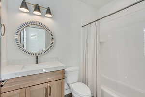 Full bath with shower / bathtub combination with curtain and vanity