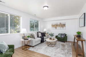 Living room with light wood finished floors and baseboards