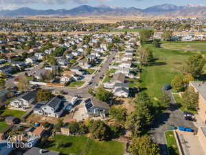 Aerial view of property's location with mountains and nearby suburban area
