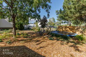 Fenced backyard with a trampoline