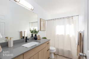Bathroom with shower / bath combo, vanity, and light tile patterned floors