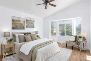 Bedroom with wood finished floors, vaulted ceiling, and a ceiling fan