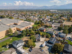 Aerial overview of property's location featuring nearby suburban area and mountains