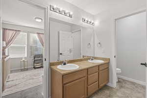 Full bath with toilet and double vanity