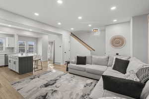 Living room with recessed lighting and light wood-style flooring