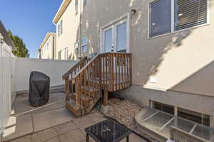 Fenced backyard with a grill and a patio
