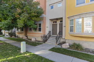 Property entrance featuring stucco siding