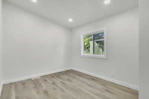 Spare room featuring light wood-style floors and recessed lighting