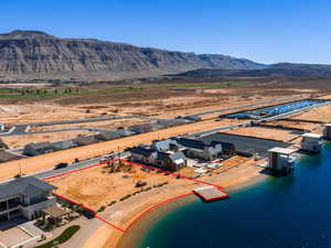 Aerial view of property and surrounding area with a mountainous background and property parcel outlined