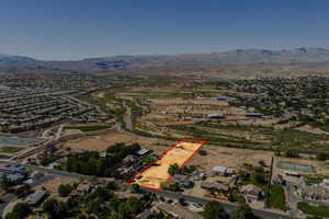 Aerial view of residential area featuring property parcel outlined and a mountainous background