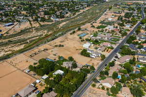 Aerial view of property and surrounding area with nearby suburban area