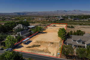 Aerial view of property's location with property parcel outlined and a mountainous background