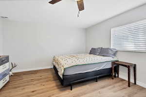 Bedroom with light wood-type flooring and ceiling fan