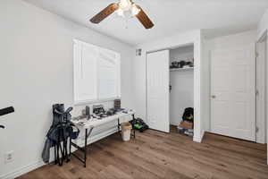 Home office featuring dark wood finished floors and ceiling fan