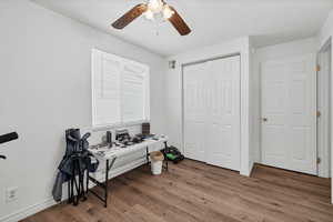 Office space featuring wood finished floors, ceiling fan, and a textured ceiling