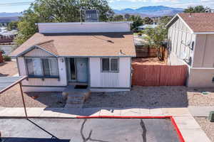 Bungalow-style house with a shingled roof and a mountain view