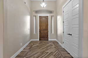Foyer featuring baseboards and wood finished floors