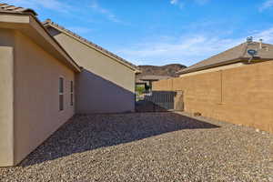 View of yard featuring a mountain view and a gate