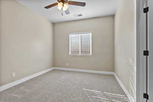 Unfurnished room featuring light colored carpet and ceiling fan