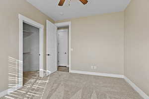 Unfurnished bedroom with carpet and a ceiling fan
