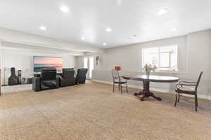 Dining room with light carpet and recessed lighting