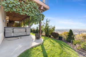 View of green lawn featuring a patio and a pergola