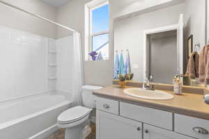 Bathroom with shower / tub combo and vanity