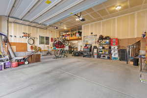 Garage featuring a workshop area and a garage door opener
