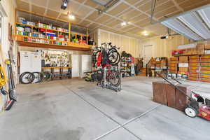 Garage with a workshop area and freestanding refrigerator