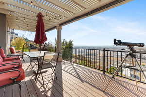 Wooden deck with outdoor dining area and a pergola