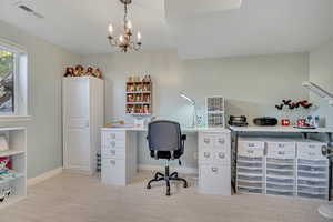 Office area featuring light colored carpet and a chandelier