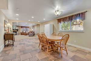 Dining space featuring a fireplace, recessed lighting, and a textured ceiling