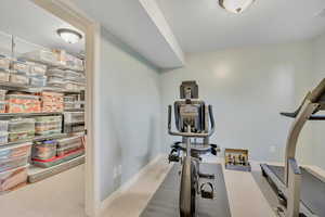 Exercise room featuring carpet flooring and a textured ceiling