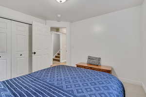 Bedroom featuring a closet, carpet flooring, and a textured ceiling