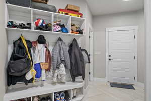 Mudroom featuring light tile patterned floors and baseboards