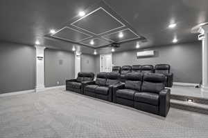 Carpeted cinema room with decorative columns and recessed lighting