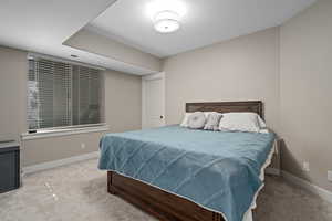 Carpeted bedroom with baseboards