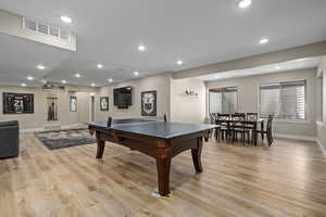 Rec room with recessed lighting and light wood-style flooring