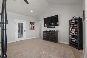 Sitting room with a ceiling fan, light carpet, recessed lighting, and high vaulted ceiling