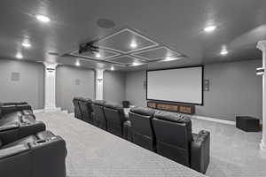 Home theater with light colored carpet, recessed lighting, and a textured ceiling