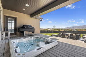 Wooden deck with grilling area and a fenced backyard