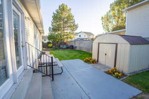 Backyard featuring a  large patio area and a storage unit