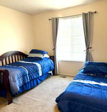 Bedroom featuring carpet flooring and baseboards
